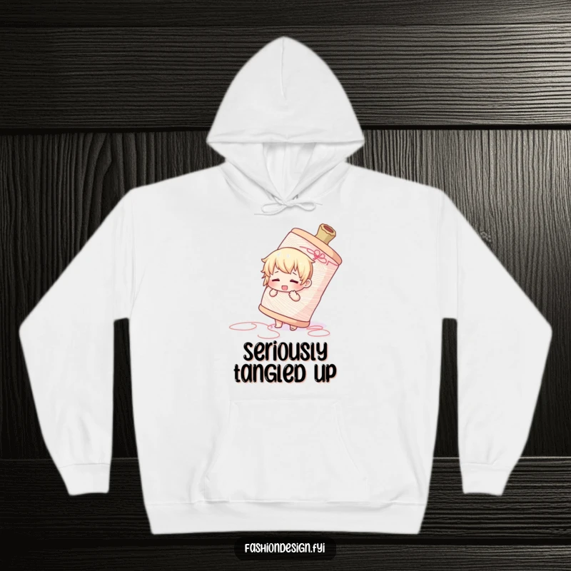 Funny hoodie depicting a cute character adorably overwhelmed by a massive spool of thread, evoking crafting chaos.