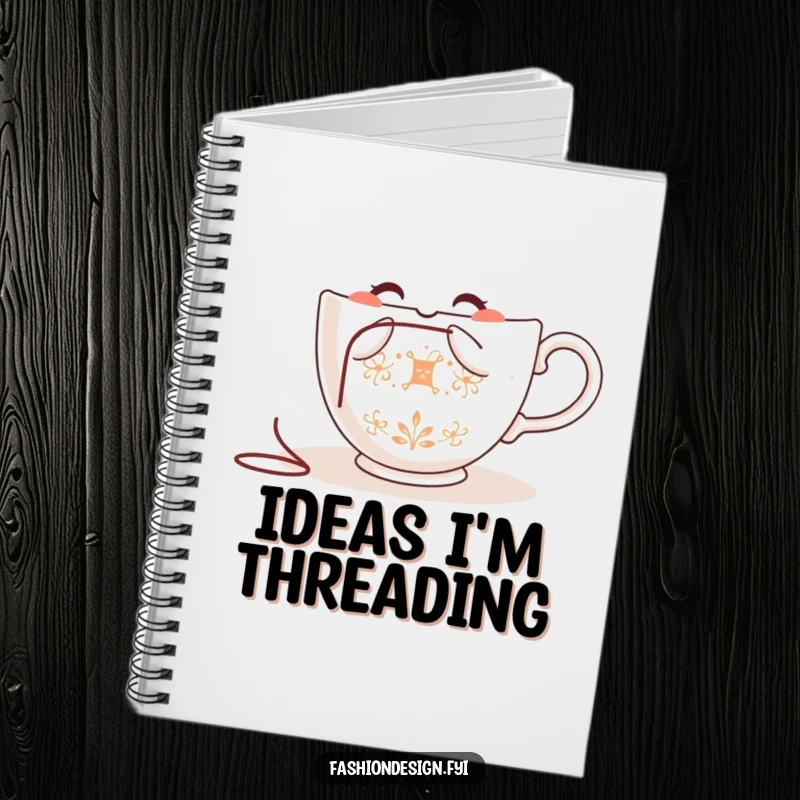 Funny teacup notebook, happy teacup character embroidering a delicate pattern, perfect for writing and sketching.